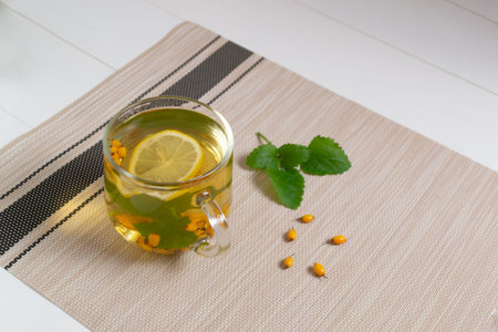 A cup of tea with and Ingredients on a brown background. Warming autumn beverage. Selective focus....