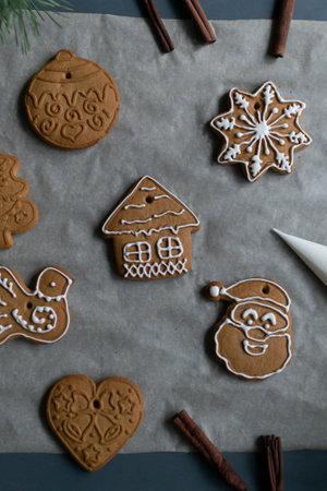 Gingerbread cookies on baking paper on a gray background. Homemade baking. Christmas holidays concept. Vertical orientation.の写真素材