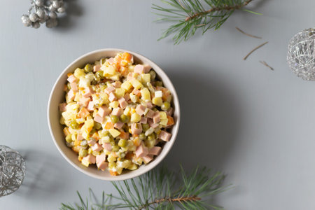 Olivier salad russian in a bowl on a gray background. Traditional and festive Russian cuisine. Copy space. Horizontal orientation.の写真素材