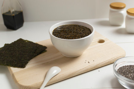 Chia seeds with soy sauce and nori seaweed with ingredients on a white background. Vegan food concept. Superfood. Horizontal orientation.の写真素材