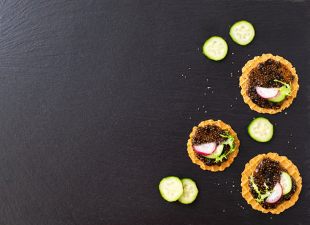 Chia seed appetizer with cucumber, radish and herbs on a dark background. Healthy eating concept. Copy space. Horizontal orientation.の写真素材