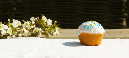 Easter cake on a white tablecloth with a branch of a blossoming apple tree. Spring holiday....