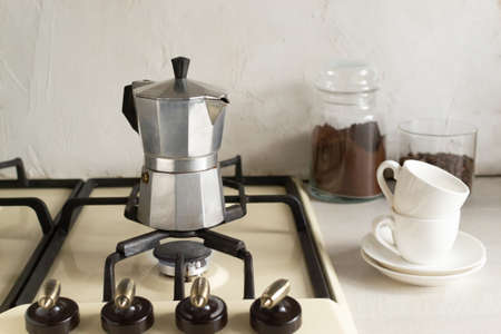 The process of making coffee at home in a geyser coffee maker on the stove in the home kitchen. Horizontal orientation.の写真素材