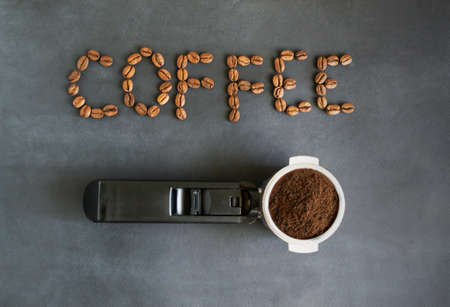 Ground coffee in a horn. Coffee Bean Lettering: Coffee. Coffee preparation concept. Horizontal orientation. Top view.の写真素材