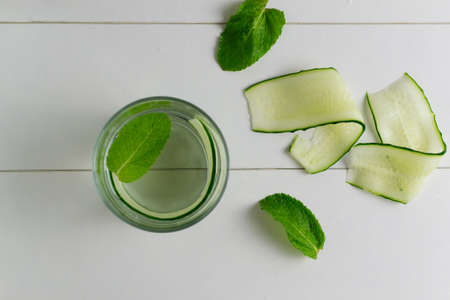 Fresh cool cucumber infused water, cocktail, detox drink, lemonade in a glass. Health care, fitness, healthy nutrition diet concept.の写真素材