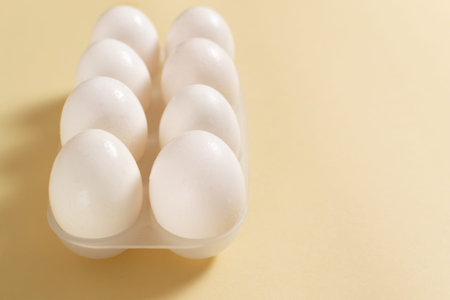 White chicken eggs lie in an egg tray. Healthy food concept. Horisontal orientation.