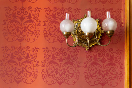 Chernivtsi, Ukraine - August 5, 2021. Antique wall lamp in the Red Hall of the Chernivtsi University of the 19th century. UNESCO World Heritage Site.Residences of the Metropolitans of Bukovina and Dalmatia.のeditorial素材