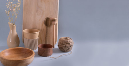 Wooden cutting board, paper cups, metal tubes, wooden dishes, glass bottle, paper egg tray, burlap jute. Eco friendly stuff concept. Vertical orientation.の写真素材