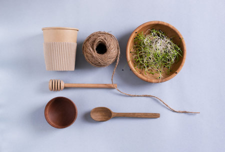 Wooden cutting board, paper cups, metal tubes, wooden dishes, glass bottle, paper egg tray, burlap jute. Eco friendly stuff concept. Vertical orientation.の写真素材