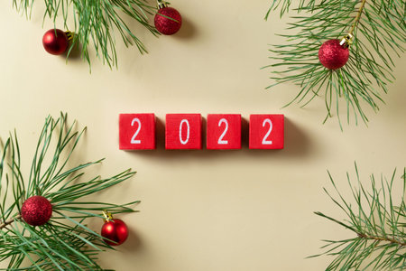 Happy New Year 2022 greeting card. Wooden cubes of red color with numbers of the coming year and...
