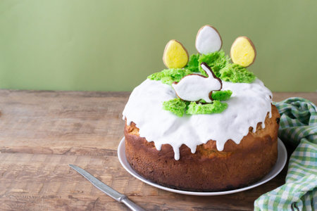 Easter cake with raisins decorated with white icing and gingerbread in the shape of Easter eggs and...