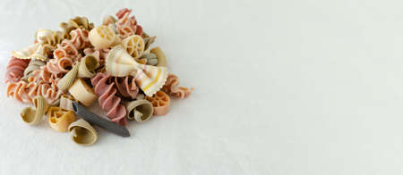 Mix of multi-colored Italian pasta on a light background. Concept alternative pasta. horizontal orientation. copyspace.の写真素材