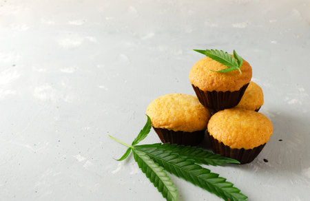 Many Marijuana cupcake muffins with cannabis leaves. gluten-free. Alternative sweet concept. horizontal orientation. selective focus. copy spaceの写真素材