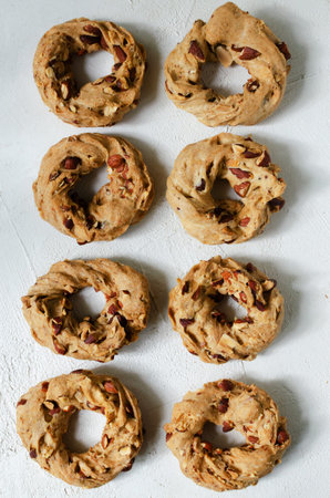 Tarallas with roasted almonds on a white background. Delicious Neapolitan pastries. Traditional Italian snacks. top view. vertical orientation.の写真素材