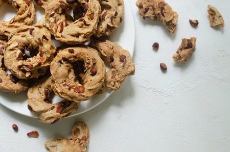 Tarallas with roasted almonds on a white plate on a white background. Delicious Neapolitan pastries....