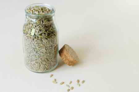 Raw freekeh or firik in a glass jar on a light background. Concept of healthy food. Vegan and...