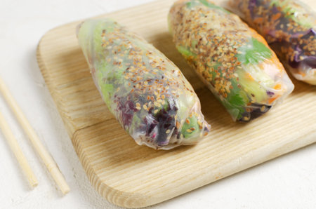 Vegetarian vietnamese spring rolls with carrot, cucumber, red cabbage, cilantro, sesame and rice...