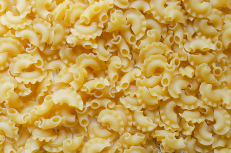 Background of Creste Di Gallo raw pasta sprinkled. Rooster comb. The concept of traditional Italian...
