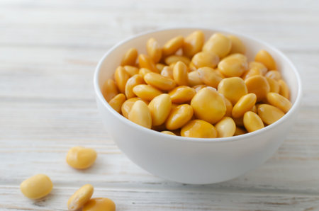 Lupine beans in a white bowl on a wooden table. Italian food. Type of legumes. Healthy food concept. Horizontal orientation. Selective focus.の写真素材