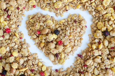 Healthy breakfast background crunchy cereal, granola, cornflakes and dried berries. Lifestyle food photography concept. Vegan and vegetarian food. Top viewの写真素材