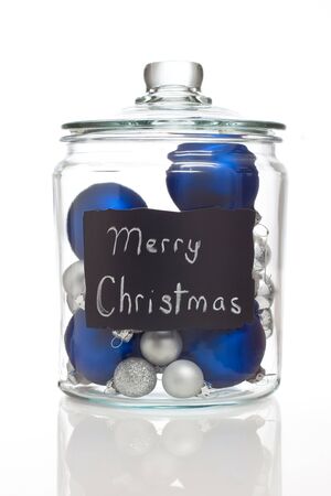 Silver and blue Christmas ornaments in jarの写真素材