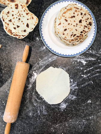 Lefse being rolled out and prepared for the holidays
