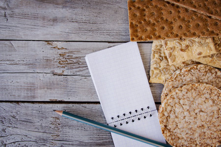 useful dietary, crispbread, flakes, buckwheat, cookies with sunflower on a textured background. A...
