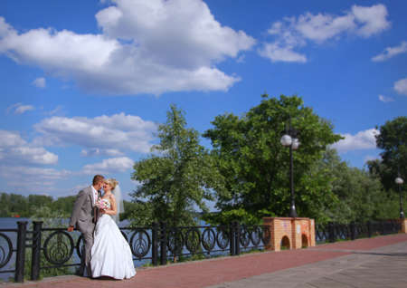 Bride and groom talking to each other on a walkingの写真素材