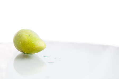 green mango on Mirror Surfaceの写真素材