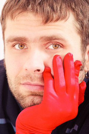 closeup portrait of handsome man with red glove gift for Valentine day