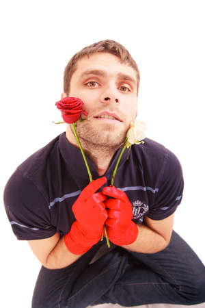 closeup portrait of handsome man in red gloves with roses gift for Valentine dayの写真素材