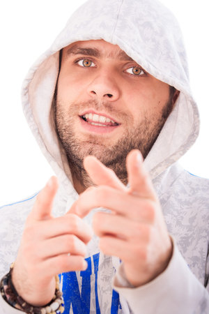 portrait handsome bearded european guy in grey hoody smiles points to camera with hands