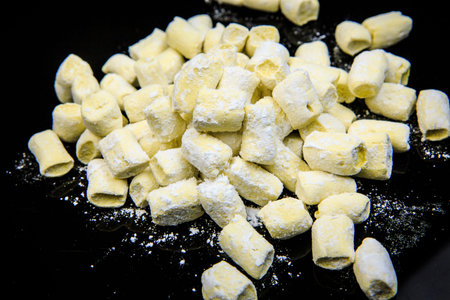 handmade white marshmallow with sugar powder  on black mirror background horizontal view