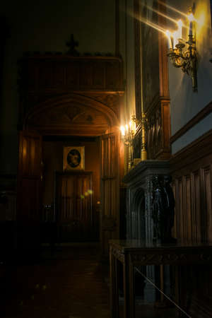Crimea Vorontsov palace interior dark room with wooden walls picture fireplace lit by candlesのeditorial素材