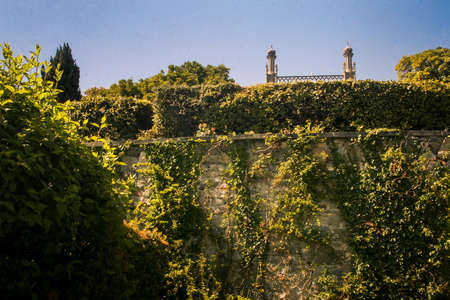 Vorontsov palace park stone breast-wall with climber plants  and small towers on skyline under sunlight in Crimeaのeditorial素材