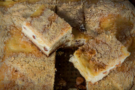 closeup sliced tasty handmade cheesecake with raisins served on wooden tabletの写真素材