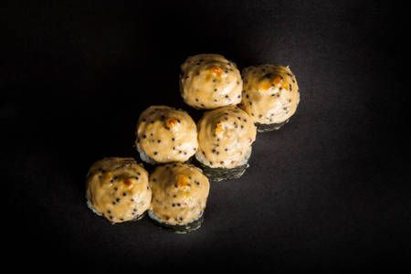 top view baked roll with smoked salmon, cucumber, philadelphia cream cheese decorated with cheese sauce served on black backgroundの写真素材