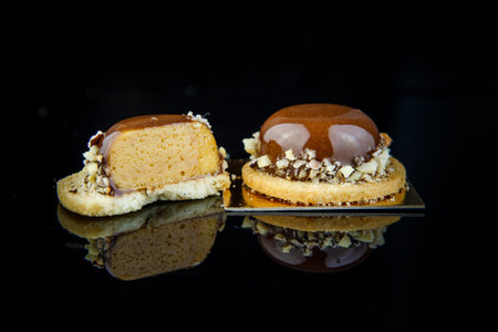 sliced on half and whole french mini mousse pastry dessert covered with chocolate glaze and crushed...