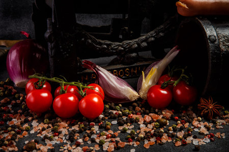 closeup big heap of spices, pink salt, tomatoes cherry, sliced red onion and raw wieners on antiquarian scalesの写真素材
