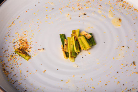 top view closeup green bamboo slices decorated with assorted herbs on modern round white restaurant...