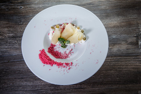 top view on original restaurant dessert finely decorated with mint, pumpkin seeds and red sugar on...