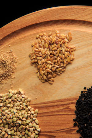 top view macro wooden board with assorted groat handfulsの写真素材