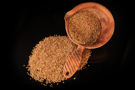 top view of dried organic coriander seeds in clay bowl and near
