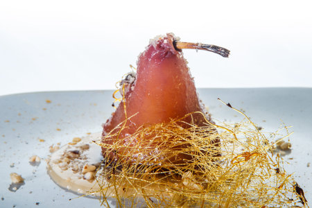 closeup homemade whole pear finely decorated with caramelの写真素材