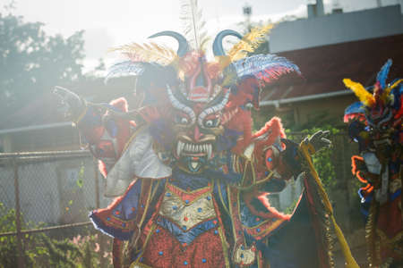 native man defile in colorful costume at dominican traditional carnival annual eventのeditorial素材