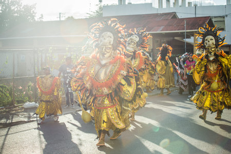 people in colorful costumes march at Dominican traditional carnival annual event