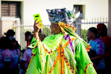 Concepcion De La Vega, DOMINICAN REPUBLIC - FEBRUARY 09, 2020: native man in motley costume take...