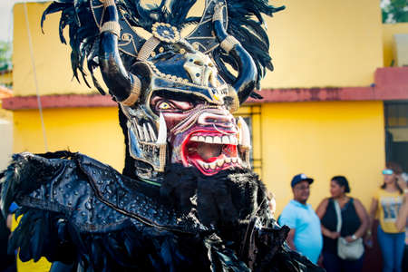 Concepcion De La Vega, DOMINICAN REPUBLIC - FEBRUARY 09, 2020: closeup person in scary black devil costume poses for photo at dominican carnival on February 9 in Concepcion De La Vegaのeditorial素材