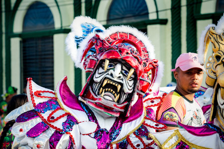 Concepcion De La Vega, DOMINICAN REPUBLIC - FEBRUARY 09, 2020: closeup men in motley masquerade costumes pose for photo at dominican carnival on February 9 in Concepcion De La Vegaのeditorial素材