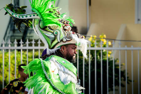 Concepcion De La Vega, DOMINICAN REPUBLIC - FEBRUARY 09, 2020: closeup native man in colorful costume passes by city street at dominican carnival on February 9 in Concepcion De La Vegaのeditorial素材